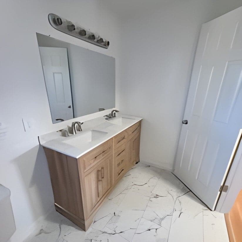Finished bathroom vanity with marble countertop and mirror