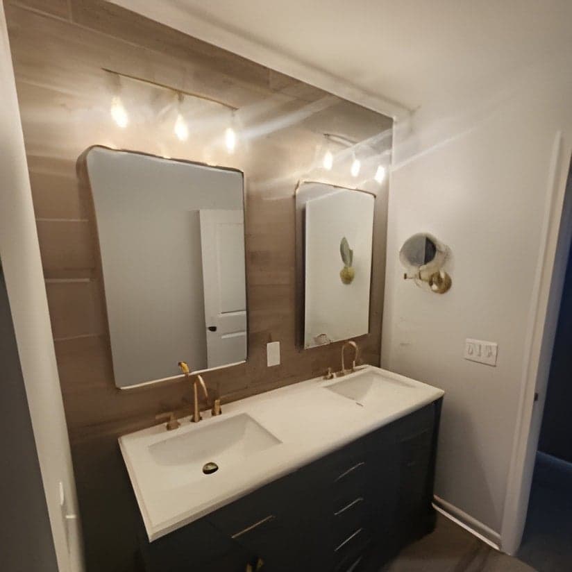 Modern bathroom vanity with dual mirrors and contemporary lighting