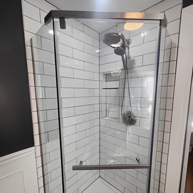 Finished shower enclosure with subway tile and glass doors