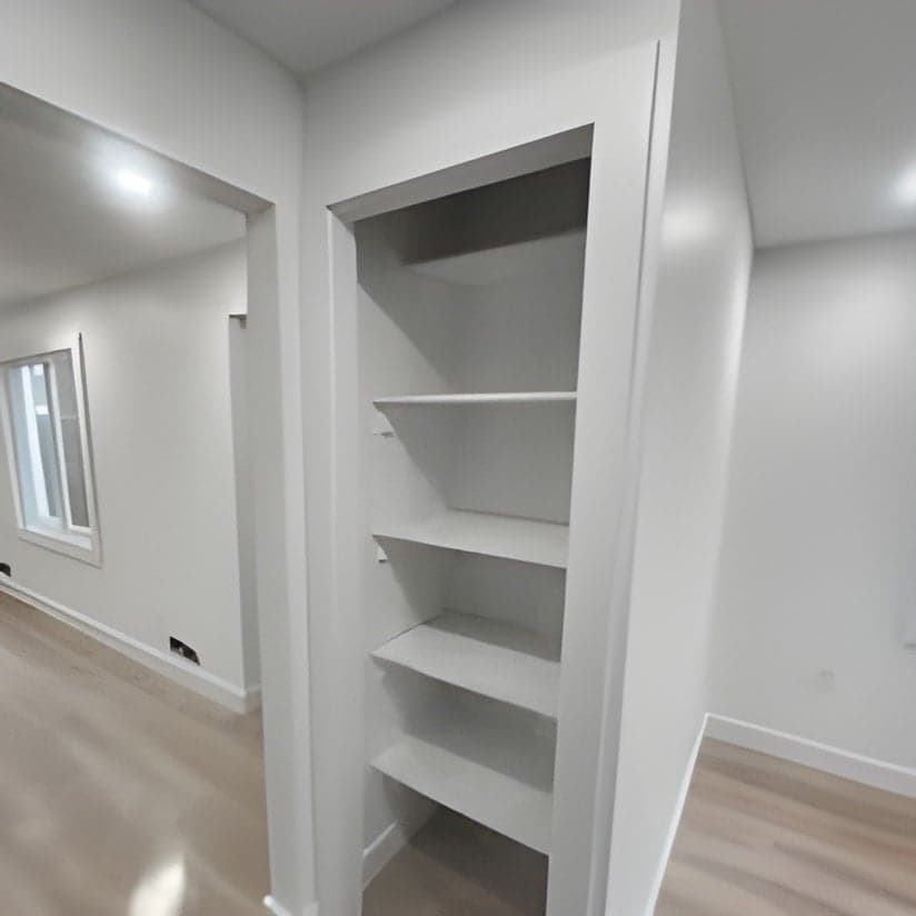 White built-in closet shelving with open door display