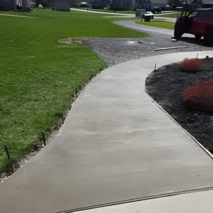 Finished concrete walkway with landscaping border