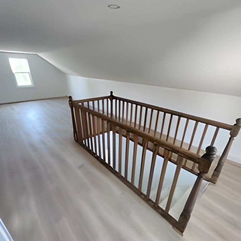 Finished upstairs loft with hardwood flooring and wooden railings