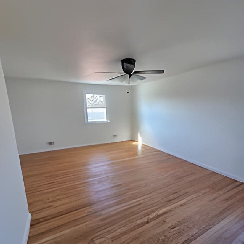 Finished interior room with wood flooring and ceiling fan