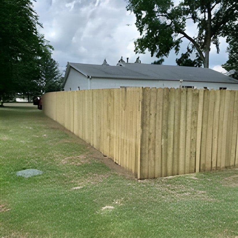 Newly installed wooden privacy fence along residential property