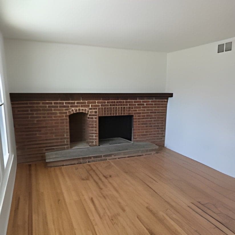 Living room with brick fireplace and hardwood flooring
