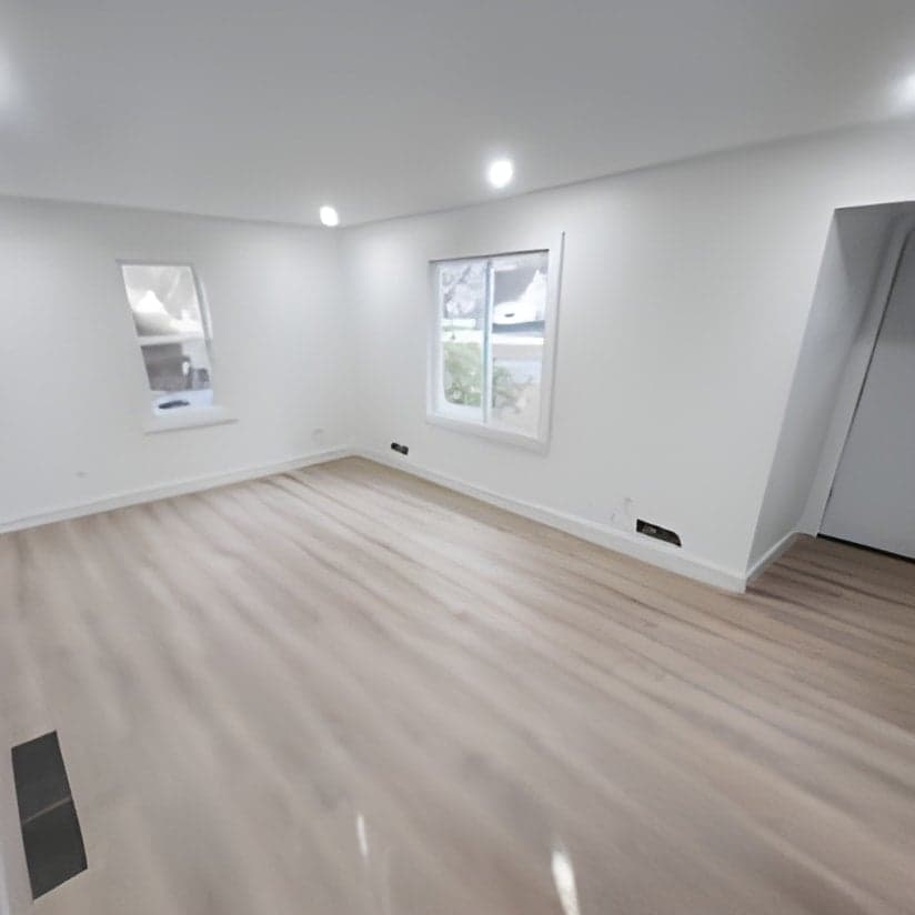 Empty room with new flooring and windows installed