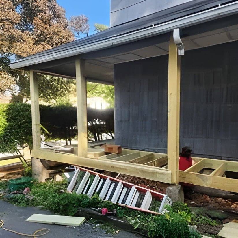 Covered porch addition under construction with framing visible