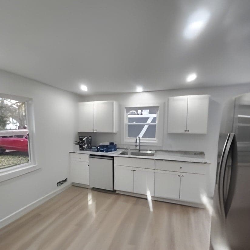 Modern kitchen with white cabinetry and stainless steel appliances