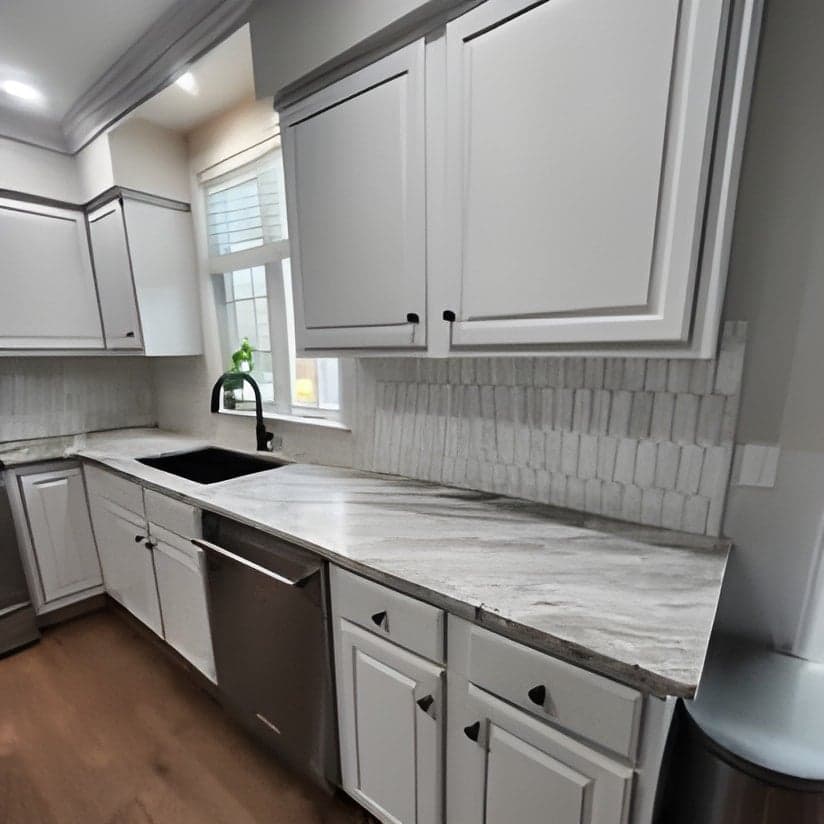 Modern white kitchen with marble countertops and subway tile backsplash