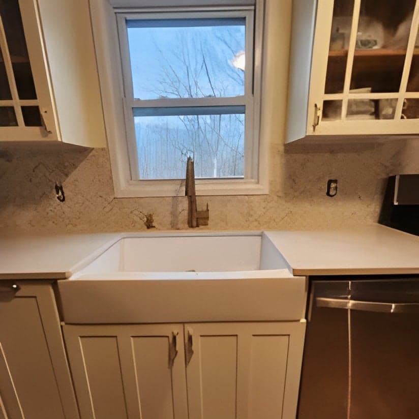 Finished kitchen with farmhouse sink and dual vanities