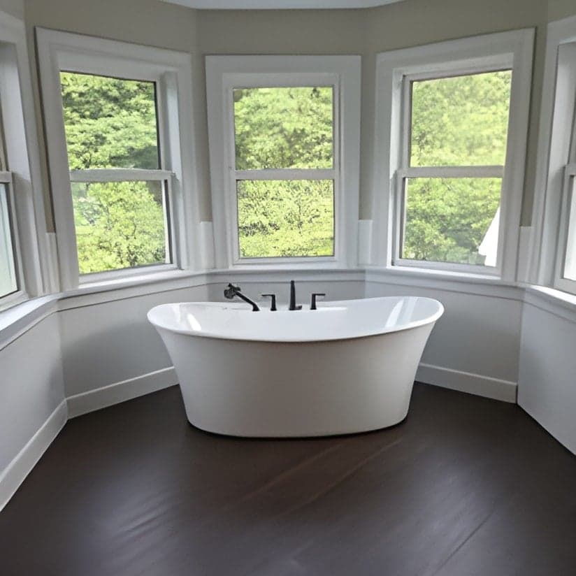 Luxurious freestanding soaking tub with bay windows
